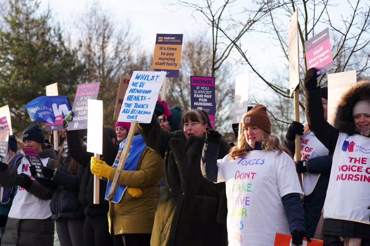 Industrial strike action in the UK as nurses join picket line.