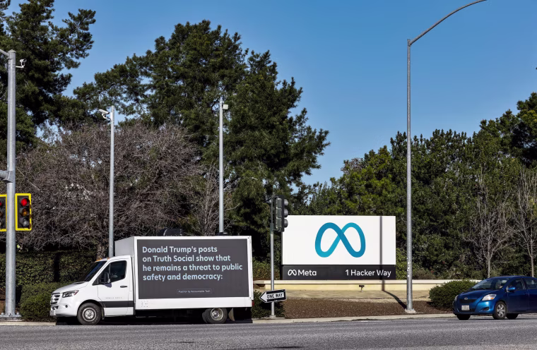 A mobile billboard, deployed by Accountable Tech, is seen outside the Meta headquarters in Menlo Park, Calif.