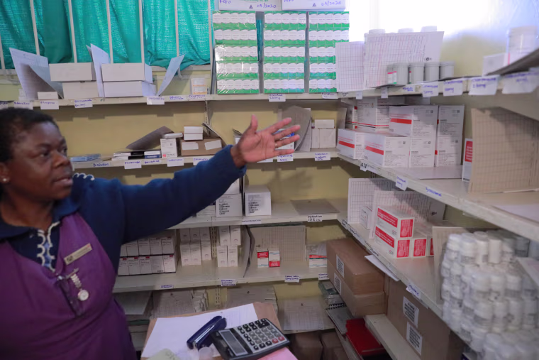 A health care worker in the store closet of the Rutsanana Primary Care Clinic, which provides
care and treatment for people with HIV in Harare, Zimbabwe.
