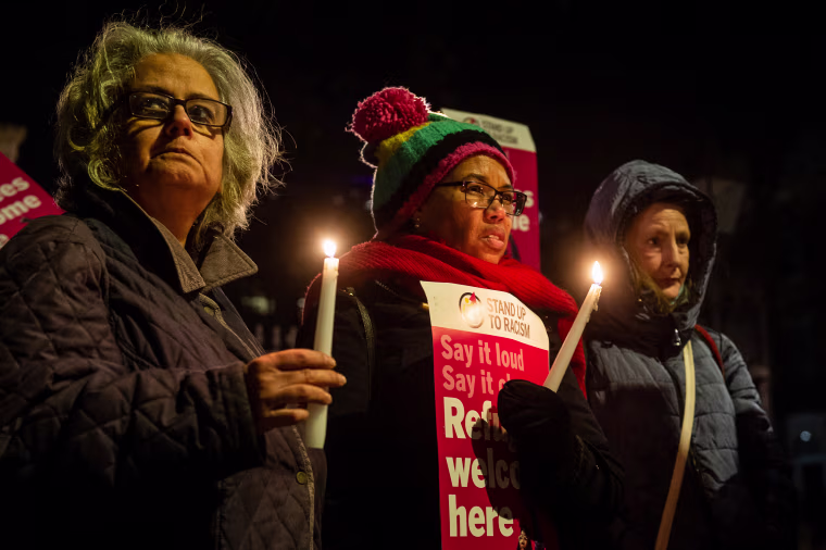 People attend a vigil outside Downing street to remember the four people who drowned in the English Channel the previous day and demand safe passage for refugees on Dec. 15, 2022, in London.