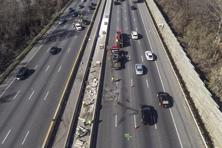 Image: Emergency personnel work at the scene of a fatal crash along Interstate 695 on March 22, 2023, near Woodlawn, Md.