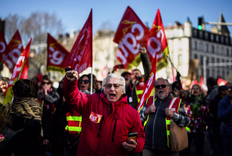 People protest after the government pushed a pensions reform through parliament without a vote in Clermont-Ferrand, France, on March 28, 2023.