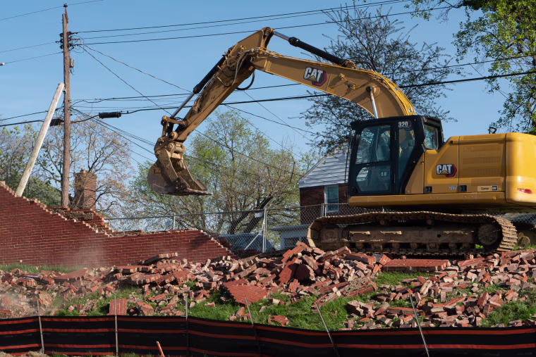 Construction workers demolish the "Spite Wall" at Morgan State University in Baltimore