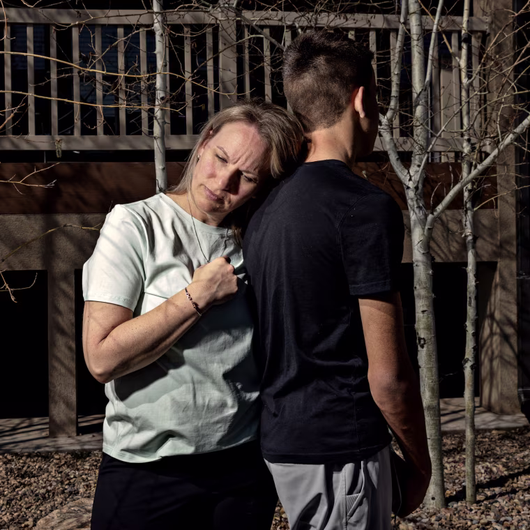 Heather McConne holds her son at their home in Layton, Utah