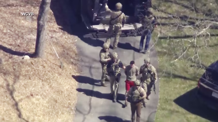 Jack Teixeira is taken into custody by armed tactical agents on April 13, 2023, in Dighton, Mass. 