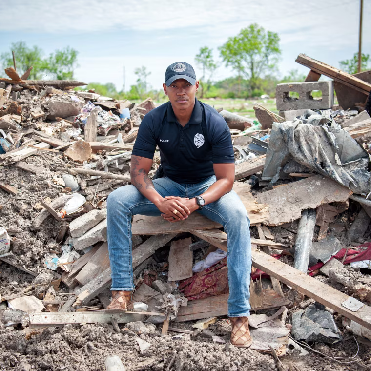 Image: Police officer Robert Barfield Jr. at a destroyed mobile home park where he rescued tornado victims in Rolling Fork, Miss.