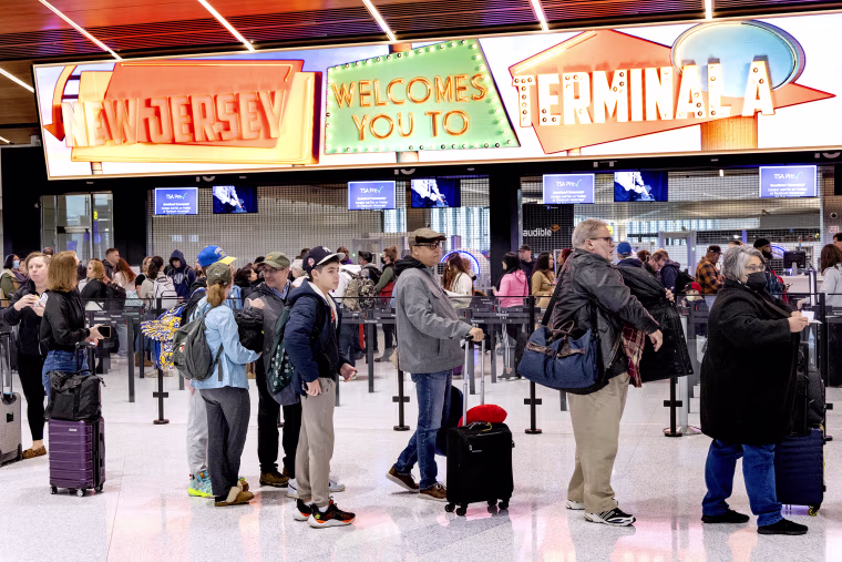 Travelers stand in line to pass through a security checkpoint at Terminal A at Newark Liberty International Airport (EWR) in Newark, N.J. on Jan. 12, 2023.