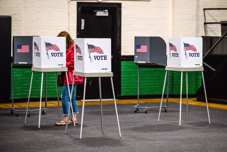  A voter casts their ballot in the Kentucky Primary Elections at polling place in the Simpsonville Community Gym on May 16, 2023 in Simpsonville, Ky.