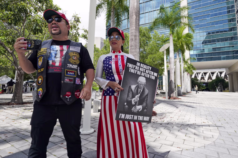 Supporters of Donald Trump, Binh Vo, left and his wife Trang Ngoc, stand outside the Wilkie D. Ferguson Jr. U.S. Courthouse in Miami
