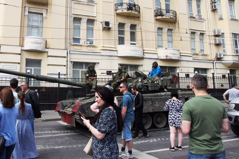 Members of Wagner group sit atop of a tank in a street in Rostov-on-Don, Russia