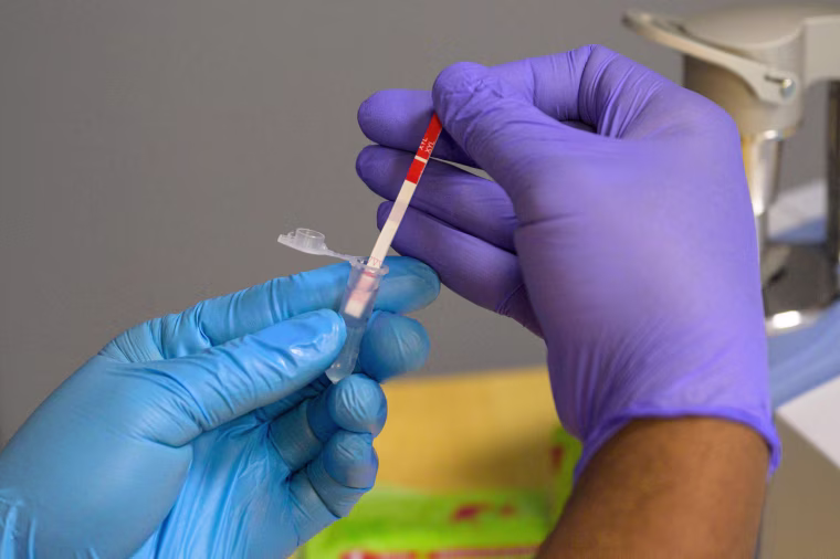 A field researcher with the New York City Department of Health tests a heroin sample for xylazine on May 25, 2023.