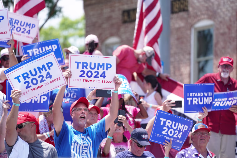 People cheer for former President Donald Trump during a campaign event in Pickens, S.C.