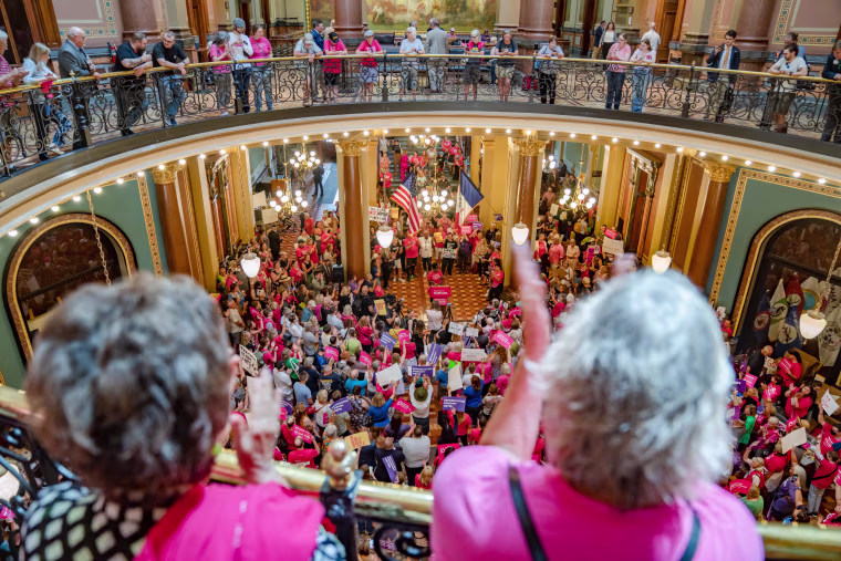 Protesters rally for reproductive rights in the Iowa State Capitol rotunda on July 11, 2023.