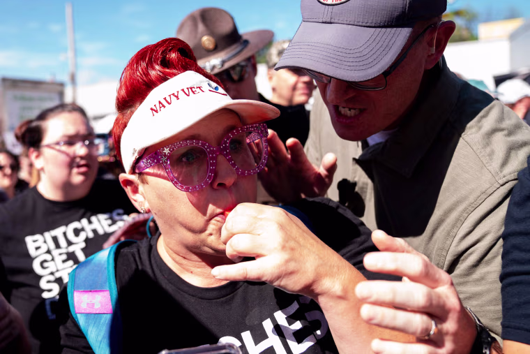 A demonstrator clashes with security as Gov. Ron DeSantis speaks at the Iowa State Fair