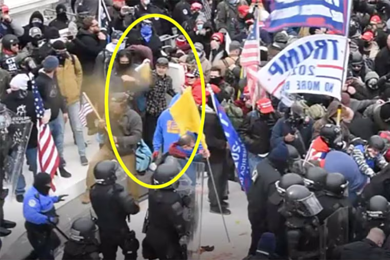 Sean Michael McHugh appears to use bear spray while outside the U.S. Capitol on Jan. 6, 2021.