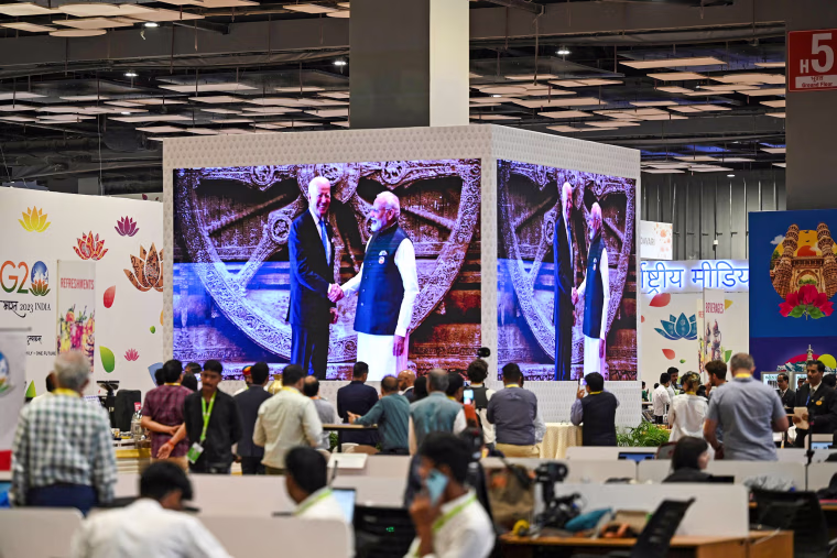 Journalists watch a screen showing live telecast of first session of the G20 Leaders' Summit in New Delhi on Sept. 9, 2023.