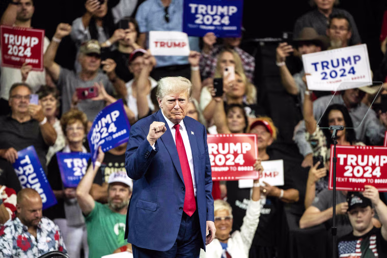 Former US president and 2024 Republican Presidential hopeful Donald Trump gestures as he leaves the stage after speaking during the South Dakota Republican Party's Monumental Leaders rally at the Ice Arena at the Monument in Rapid City, South Dakota, September 8, 2023.