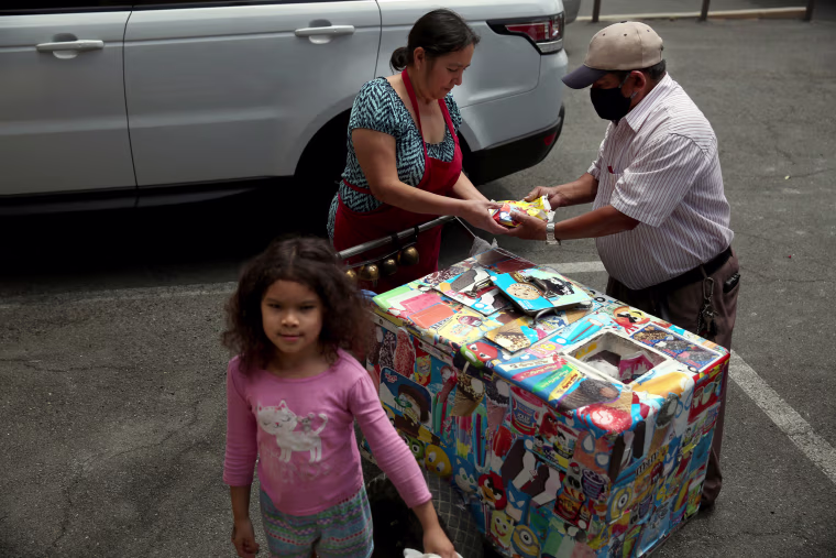 IMage: Mauro Rios Parra sells paletas in Pic Union, near Los Angeles, in 2020. Parra came to the United States from Mexico 20 years ago, and has sold paletas to support his family.