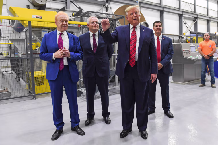 Then-President Donald Trump speaks as Anthony Pratt, left, the executive global chairman of Pratt Industries and Australian Prime Minister Scott Morrison look on during a visit to a Pratt Industries plant opening in Wapakoneta, Ohio.