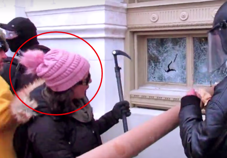 Rachel Powell strikes a window at the Capitol with an ice axe on Jan. 6, 2021.