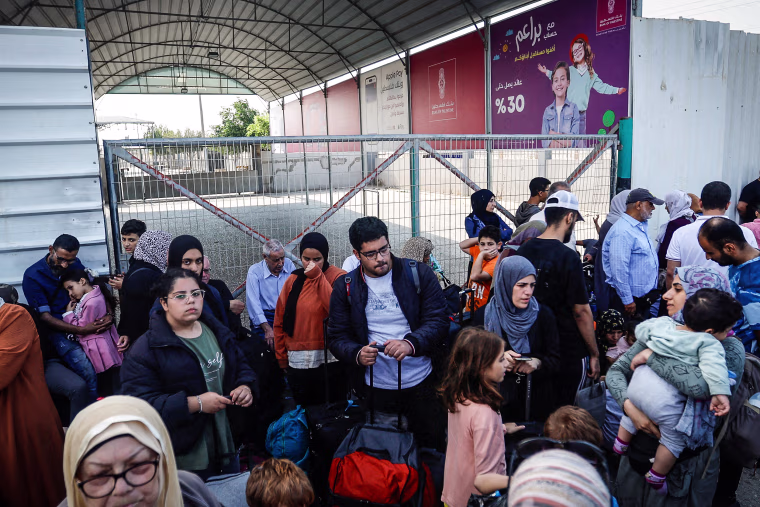 Palestinians with dual citizenship gather outside Rafah border crossing with Egypt