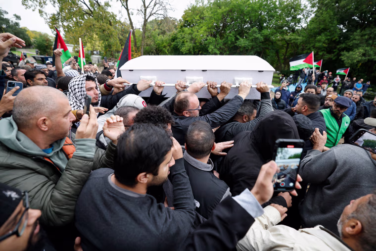 Mourners carry the coffin Wadea Al-Fayoume during his funeral