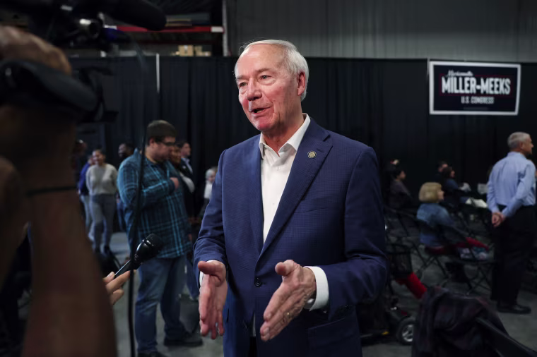 Former Gov. Asa Hutchinson speaks to the press
