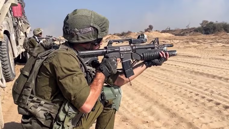 An IDF soldier points his gun in northern Gaza.