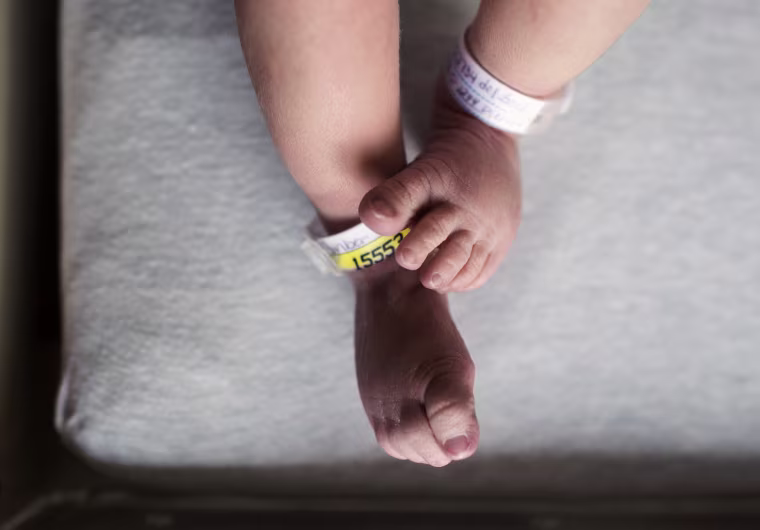 The feet and legs of a newborn baby born at a hospital