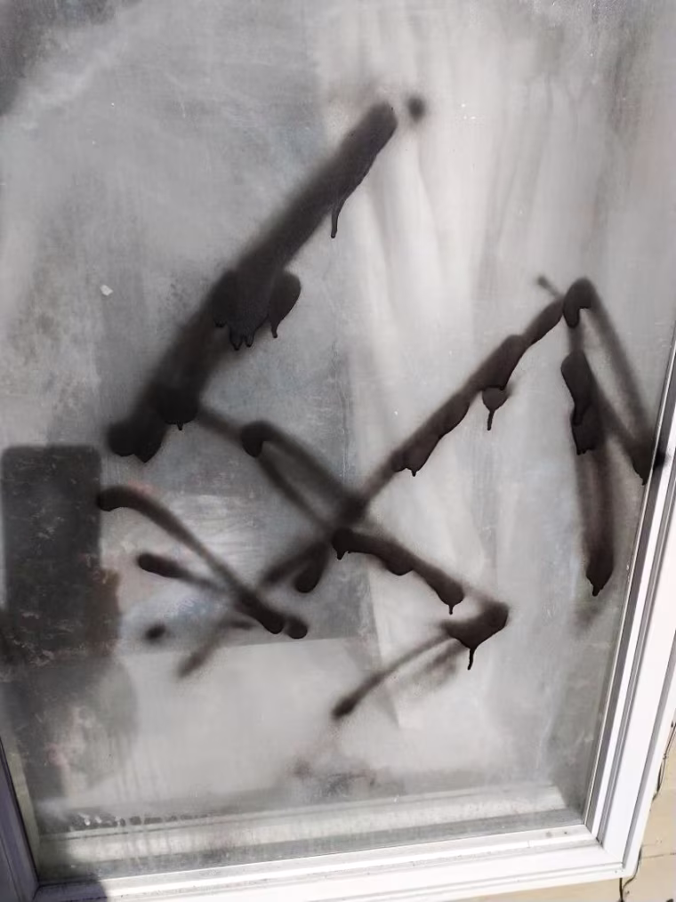 A swastika spray-painted on the side of the Belknap County Democratic Party office.