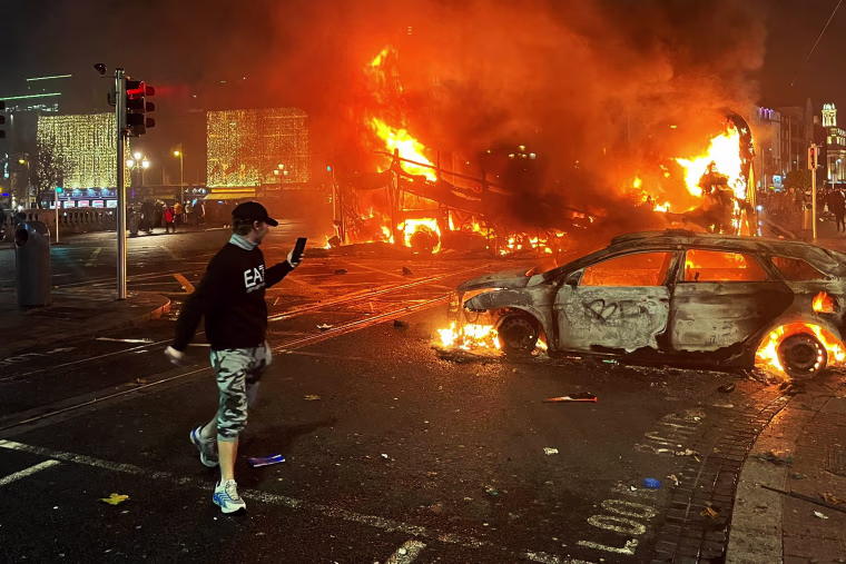 Protesters in Dublin on Thursday torched a car and fought police, an AFP journalist reported, after three children were injured in a suspected school stabbing that social media rumours attributed to a foreign national. 