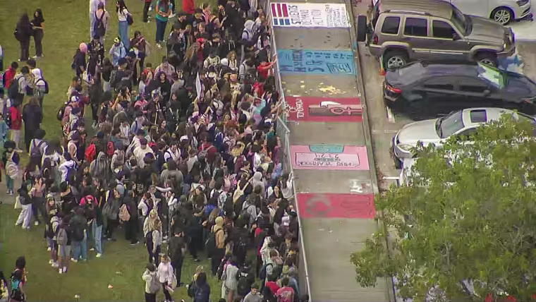 Students at at Monarch High School in Coconut Creek walked out of class around noon Tuesday to protest the reassignment of Principal James Cecil and staffers.