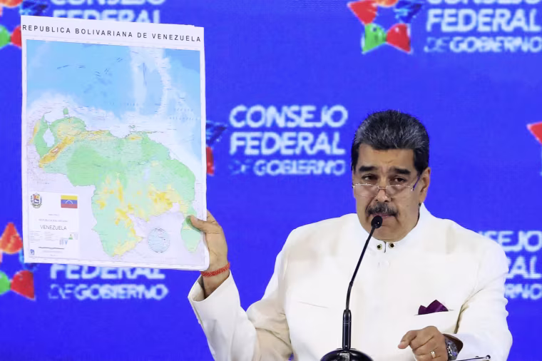 Venezuela's President Nicolas Maduro (R) speaking next to Bolivarian National Assembly President Jorge Rodriguez during a meeting of the Assembly of the Federal Council of Government at Miraflores Presidential Palace in Caracas on December 5, 2023. 