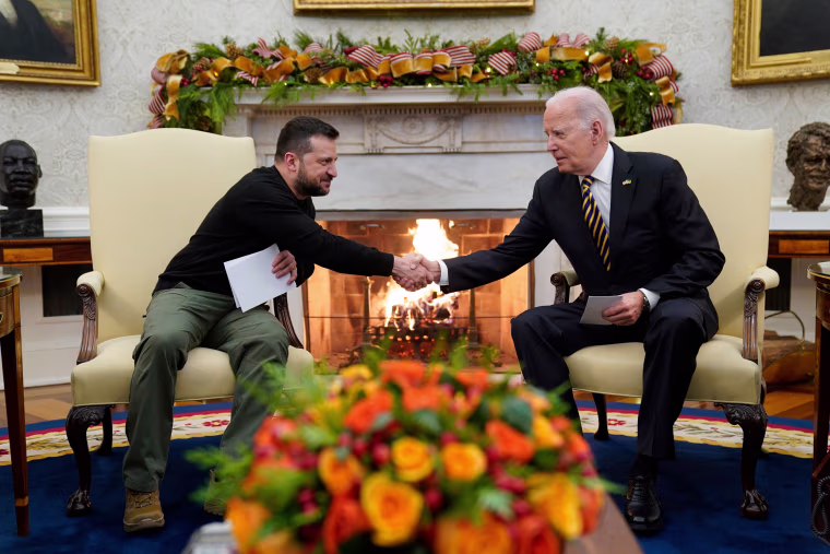 President Joe Biden shakes hands with Ukrainian President Volodymyr Zelenskyy.