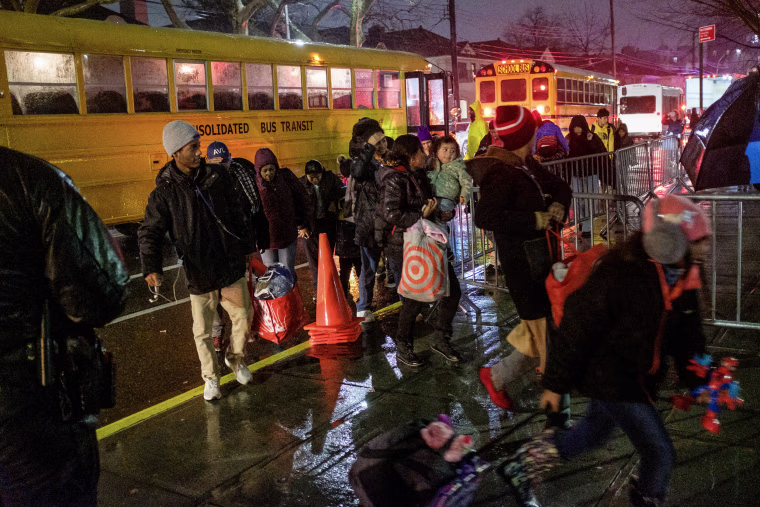 Migrants evacuated from Floyd Bennett Field arrive at James Madison High School on Bedford Avenue in Brooklyn, New York during a storm on Jan. 9, 2024.