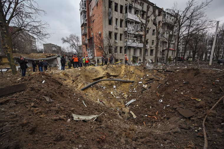 A crater outside a damaged residential building in Kharkiv, Ukraine, Tuesday, Jan. 2, 2024.