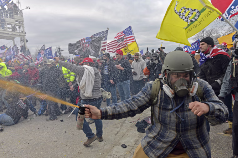 Trump supporters, including the "blueplaidsprayer," clash with police at the Capitol on Jan. 6, 2021.
