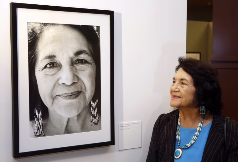 Dolores Huerta, co-founder of United Farms Workers stands by a portrait of herself taken in1998 by photographer Angela Torres, as she tours her exhibition, "Viva la Causa! Dolores Huerta and the Struggle for Justice," at La Plaza de la Cultura y Artes museum in downtown Los Angeles.