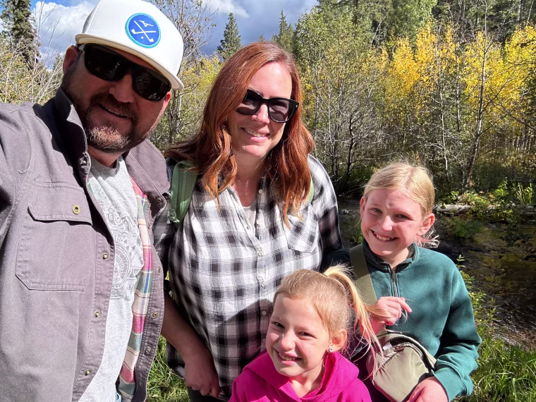 Two parents and two children on a hike. 
