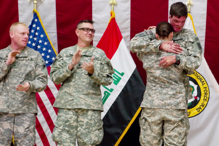 Capt. Sam Brown hugs his wife, Capt. Amy Brown, after arriving in Baghdad to take part in Operation Proper Exit.