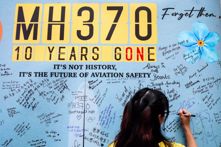 A woman writes a message on the message board