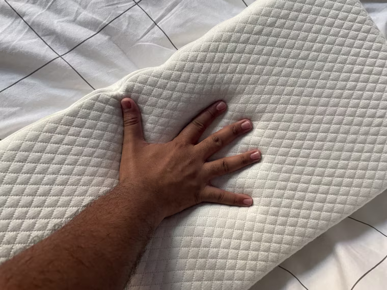 The Side Cube without a pillowcase on it and a hand pressing into the surface.