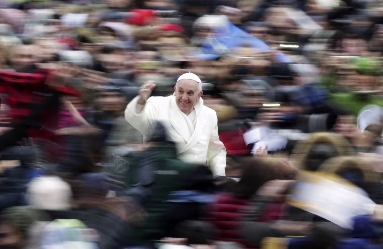 Image: Pope Francis waves as he arrives to conduct his weekly general audience at St. Peter's Square at the Vatican