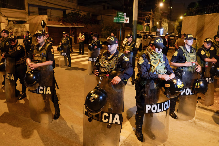 Police guard outside President Dina Boluarte's house.