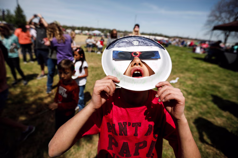 Oliver Cantwell, from Fair Grove, Mo. views the solar eclipse in West Plains, Mo. on Monday, April 8, 2024.