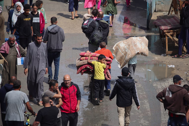 Displaced Palestinians flee Rafah as Israel orders evacuation. 