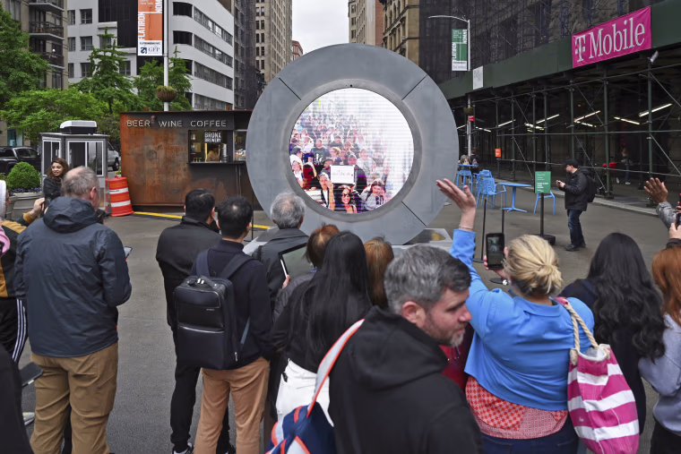 People in New York interact with a livestream video portal with Dublin.
