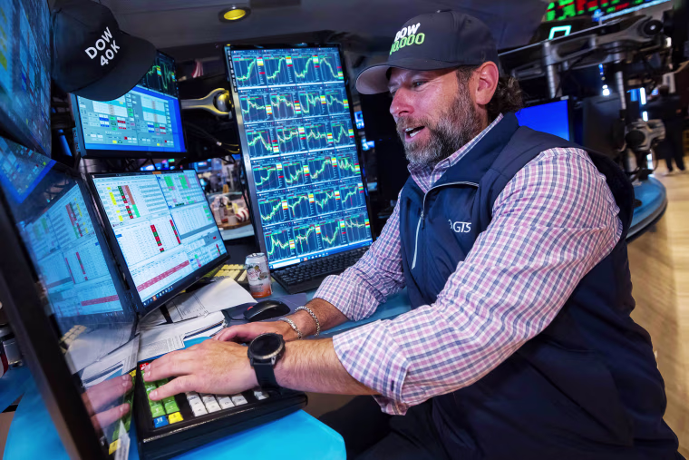 Trader smiling at his work station