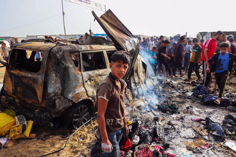 Palestinians gather at the site of an Israeli strike in Rafah on May 27, 2024.