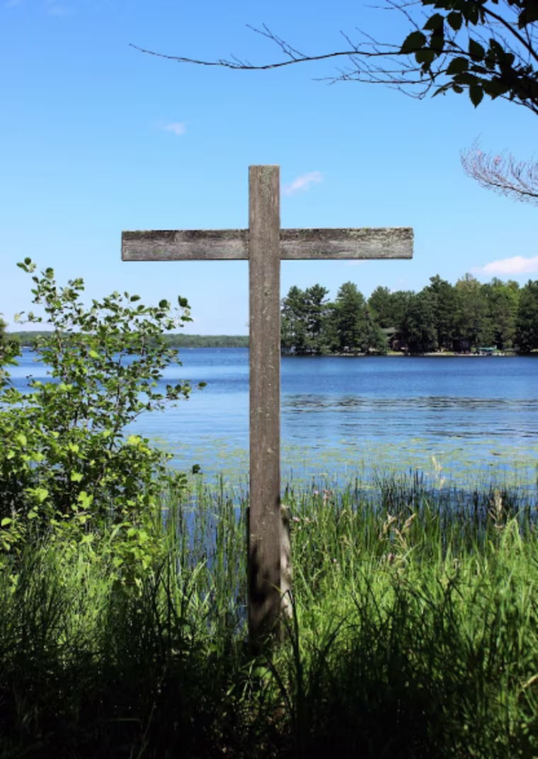A cross on the lakeside at The Naming Project.